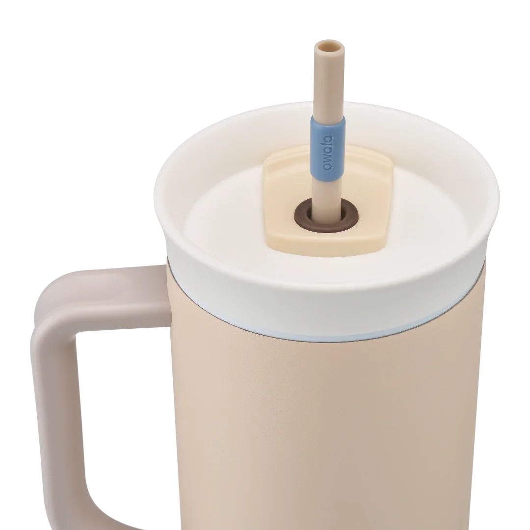 Owala stainless steel insulated tumbler with handle and straw 1185ml beige/sand base with light lid close up shot