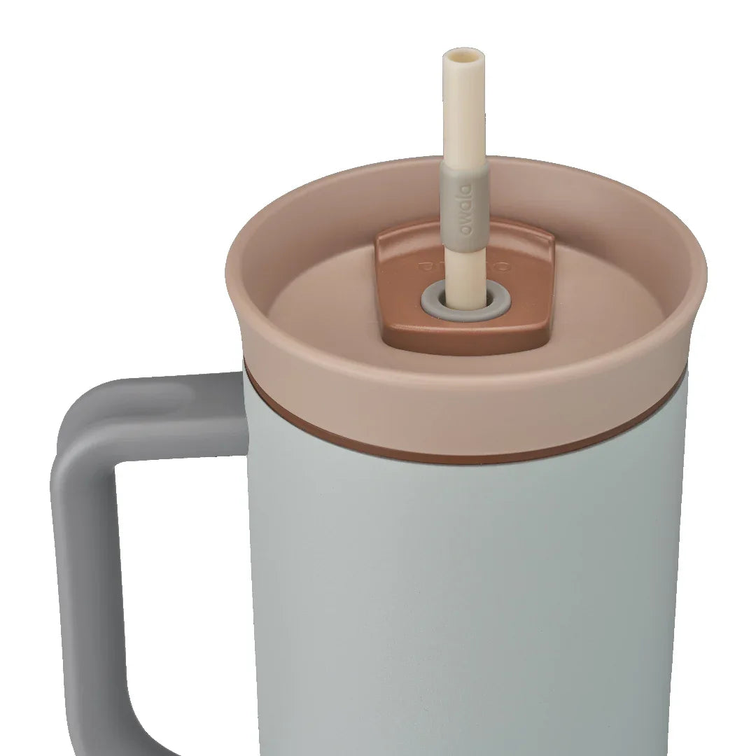 Owala stainless steel insulated tumbler with handle and straw 1185ml light base with beige lid close up shot