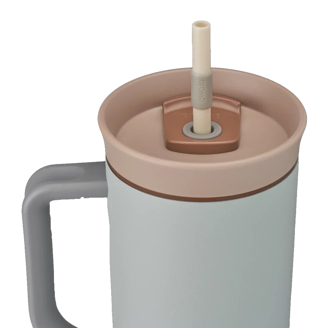 Owala stainless steel insulated tumbler with handle and straw 1185ml light base with beige lid close up shot
