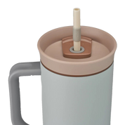 Owala stainless steel insulated tumbler with handle and straw 1185ml light base with beige lid close up shot